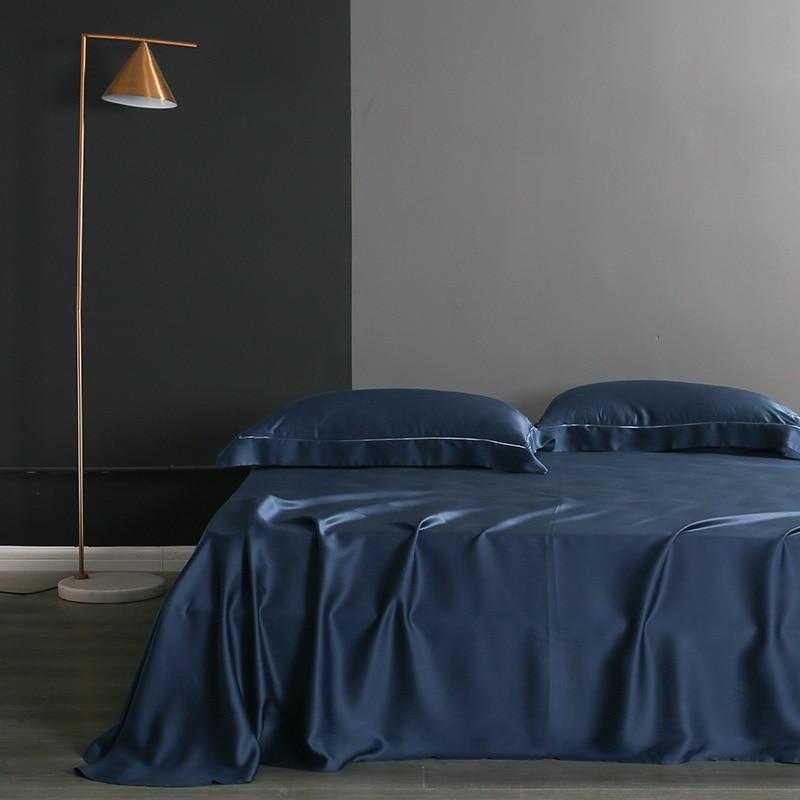 Karen Solid Color Lyocell Duvet Cover Set in navy blue with modern boho style, displayed in a stylish bedroom setting.