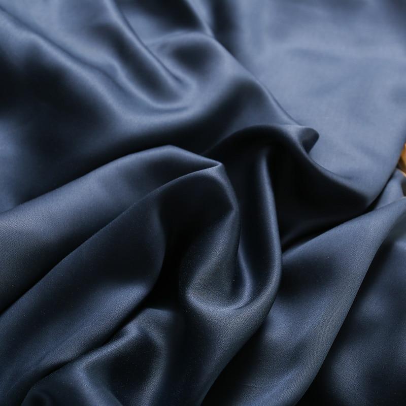 Karen Solid Color Lyocell Duvet Cover Set in navy blue, showcasing its smooth Tencel fabric and modern boho style.