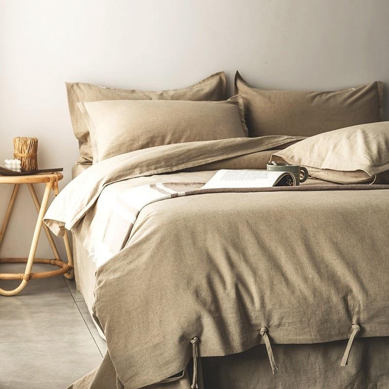 Emma Duvet Cover Set With Ropes 55% Cotton 45% Linen displayed on a neatly arranged bed with pillows and wooden side table.