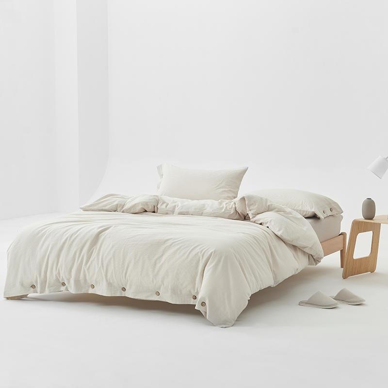 Olivia Stripe Ultra Soft Duvet Cover Set 100% Washed Cotton on stylish bed with buttons, showcasing comfort with twin to double sizes.