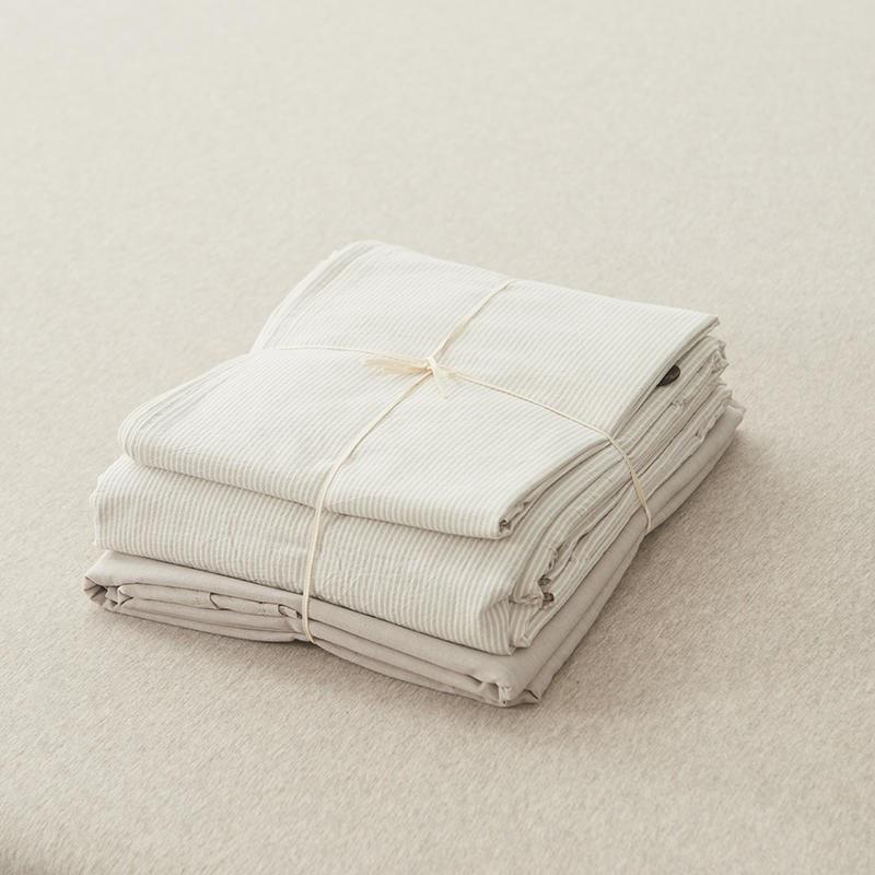 Olivia Stripe Ultra Soft Duvet Cover Set 100% Washed Cotton neatly folded on a soft bed surface.