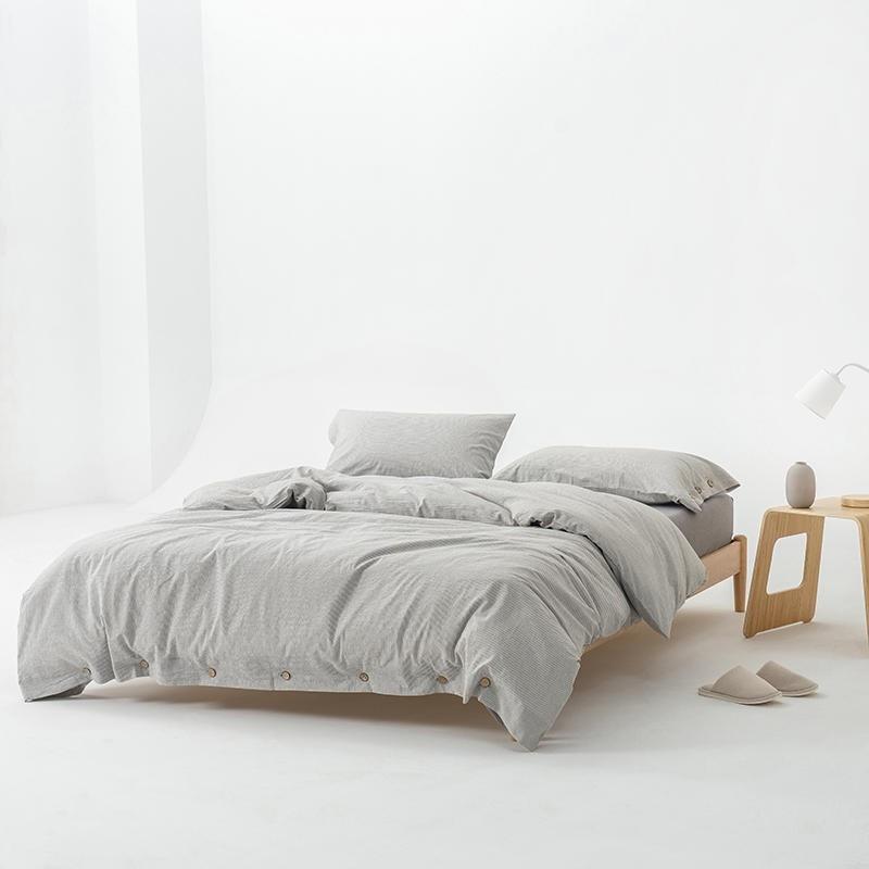 Olivia Stripe Ultra Soft Duvet Cover Set 100% Washed Cotton on a modern bed with wooden side table and slippers