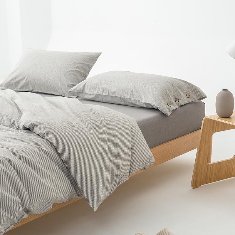 Olivia Stripe Ultra Soft Duvet Cover Set 100% Washed Cotton on contemporary wooden bed with buttons detailing.