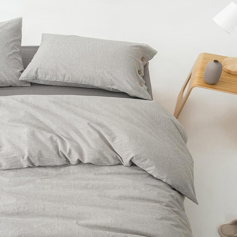Olivia Stripe Ultra Soft Duvet Cover Set 100% Washed Cotton on bed with wooden nightstand and soft grey pillows.