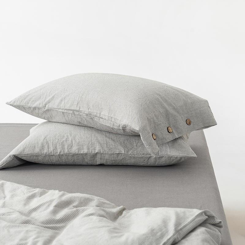 Olivia Stripe Ultra Soft Duvet Cover Set 100% Washed Cotton with button closure detail on a bed.