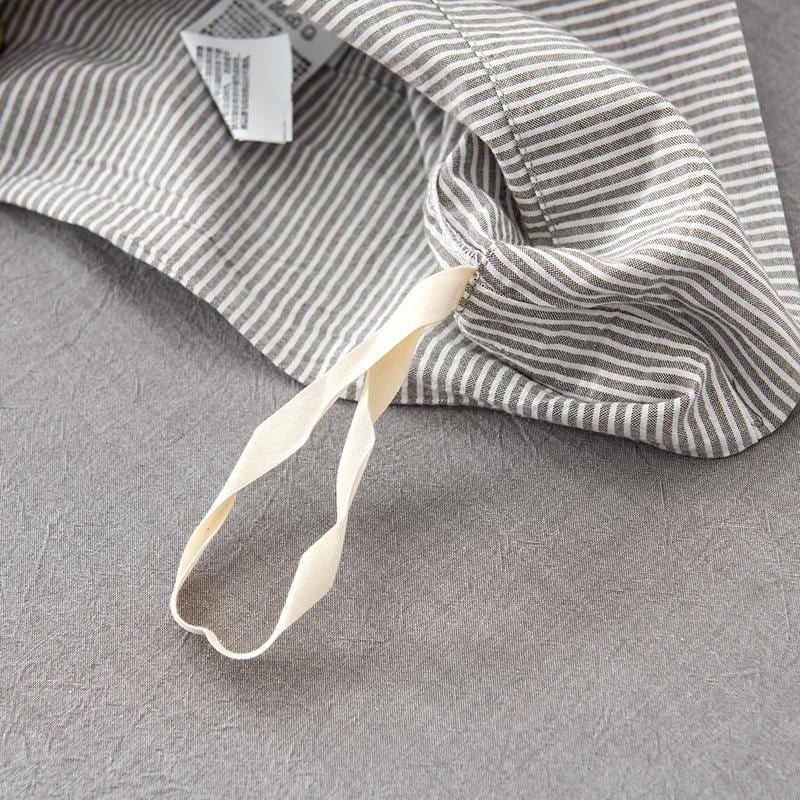 Close-up of Olivia Stripe Ultra Soft Duvet Cover Set 100% Washed Cotton showing striped pattern and button closure.