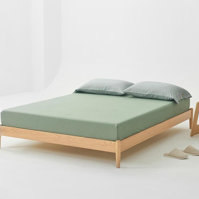 Olivia Stripe Ultra Soft Duvet Cover Set 100% Washed Cotton in green on a wooden bed frame