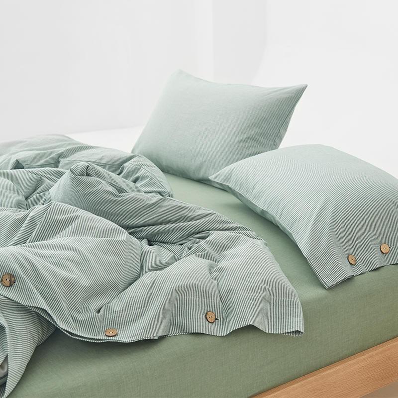 Olivia Stripe Ultra Soft Duvet Cover Set 100% Washed Cotton with buttons and pillowcases on a bed, showcasing ultra softness and elegance.