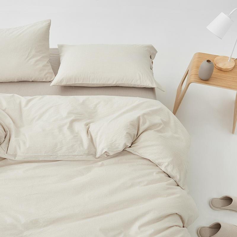 Olivia Stripe Ultra Soft Duvet Cover Set 100% Washed Cotton displayed with matching pillows and a bedside table for a cozy bedroom look.
