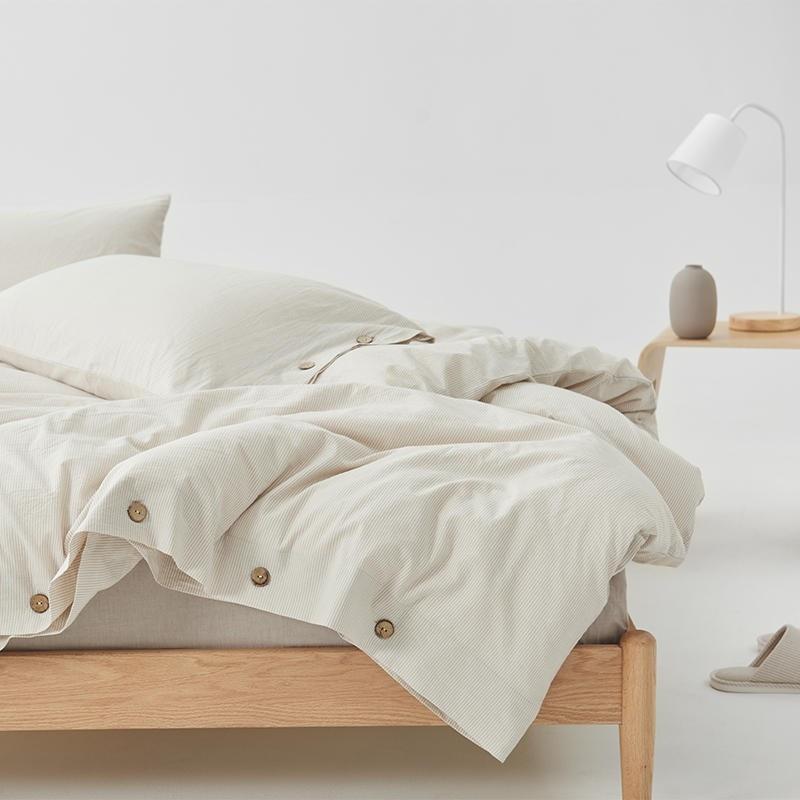 Olivia Stripe Ultra Soft Duvet Cover Set 100% Washed Cotton on a wooden bed with buttons