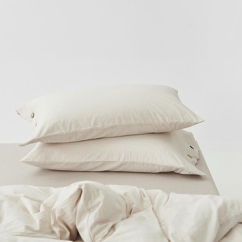 Olivia Stripe Ultra Soft Duvet Cover Set 100% Washed Cotton, featuring soft pillows and duvet with button detail on a bed.
