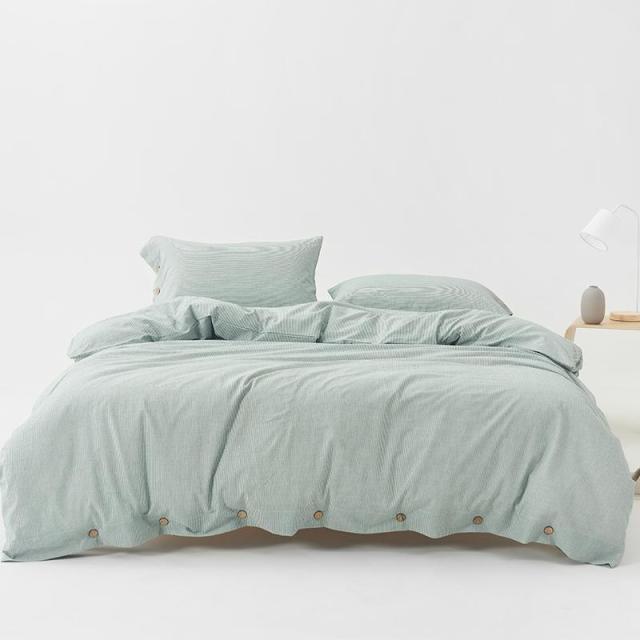 Olivia Stripe Ultra Soft Duvet Cover Set 100% Washed Cotton in light green displayed on bed.
