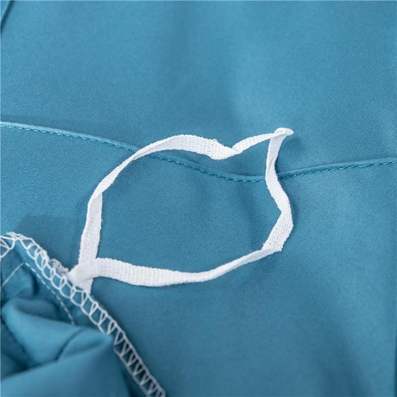Close-up of teal Charlotte Ultra Soft Microfiber Duvet Cover loop for secure fit. Ideal for all-season comfort and warmth.