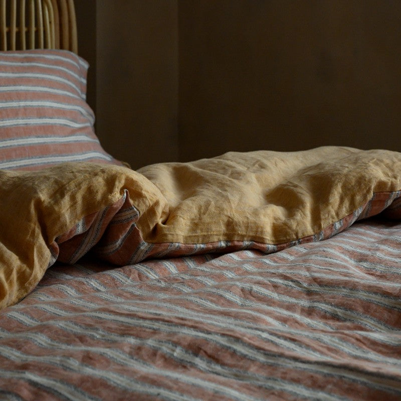 PeachPuff Vertical Stripes 100% Linen Duvet Cover Set on bed showing soft and breathable linen bedding with striped design.