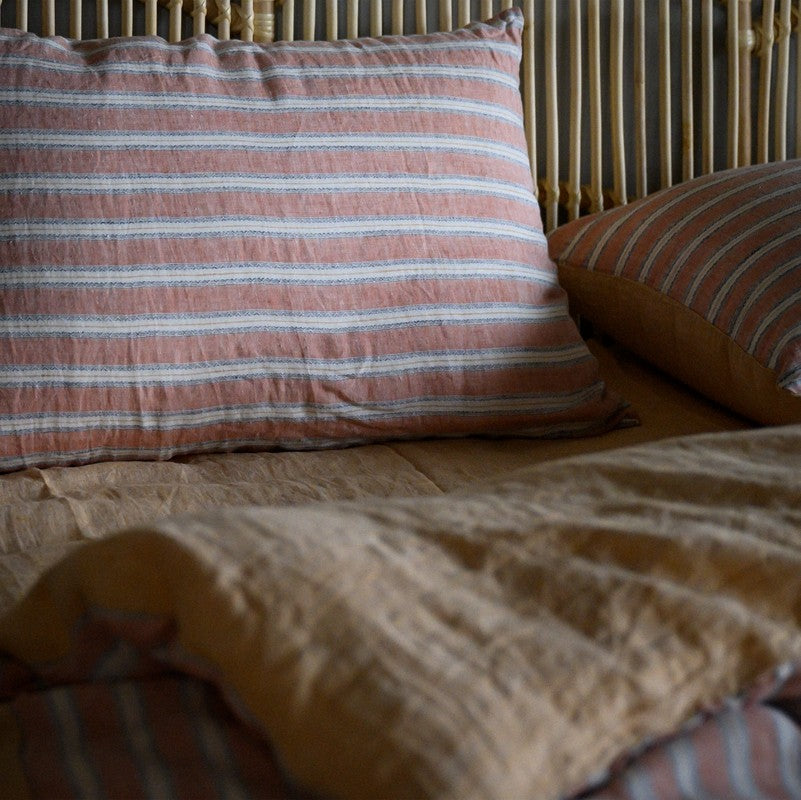 PeachPuff Vertical Stripes 100% Linen Duvet Cover Set on bed, breathable and soft, displaying pillow and duvet with stripes.