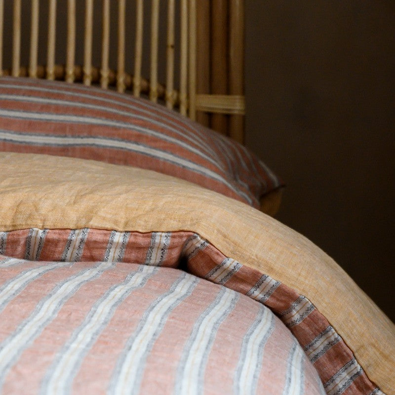 PeachPuff Vertical Stripes 100% Linen Duvet Cover Set on bed with soft and breathable fabric.