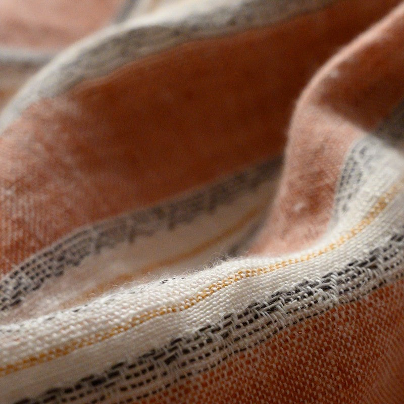 Close-up of PeachPuff Vertical Stripes 100% Linen Duvet Cover Set showing soft, breathable fabric texture and stripes.
