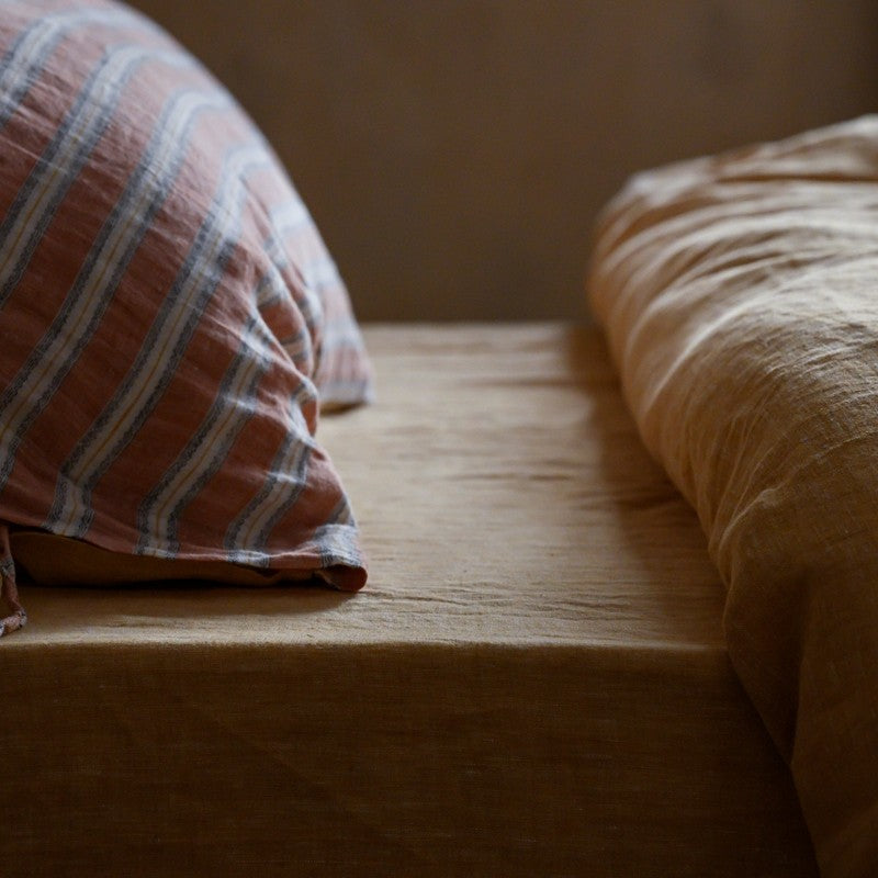 Close-up of the PeachPuff Vertical Stripes 100% Linen Duvet Cover Set showcasing its texture and design.