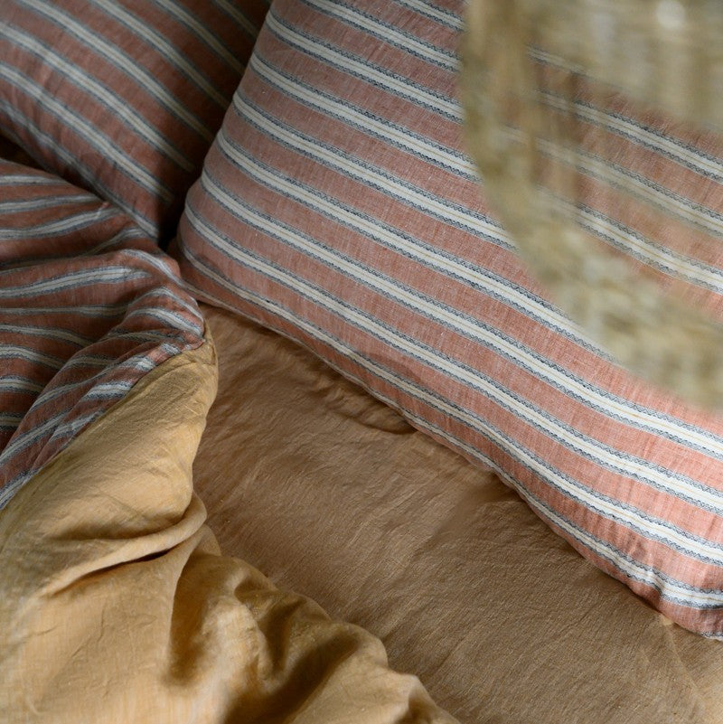 Close-up of PeachPuff Vertical Stripes 100% Linen Duvet Cover Set showcasing the breathable, soft texture and design.