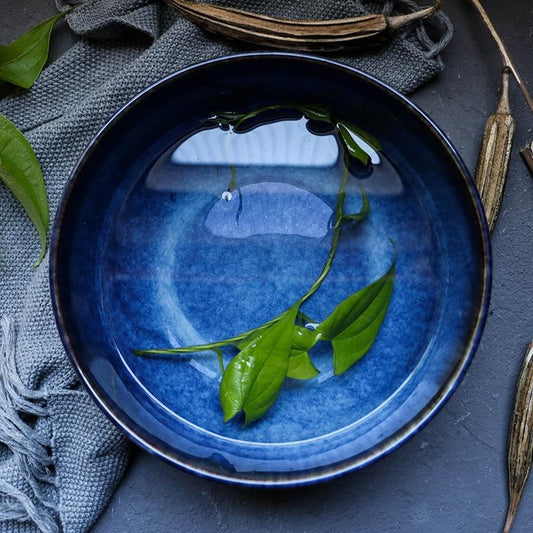 Tana Ceramic Bowl 2400ml in blue porcelain with solid pattern and eco-friendly design, featuring under glazed technique with green leaves.