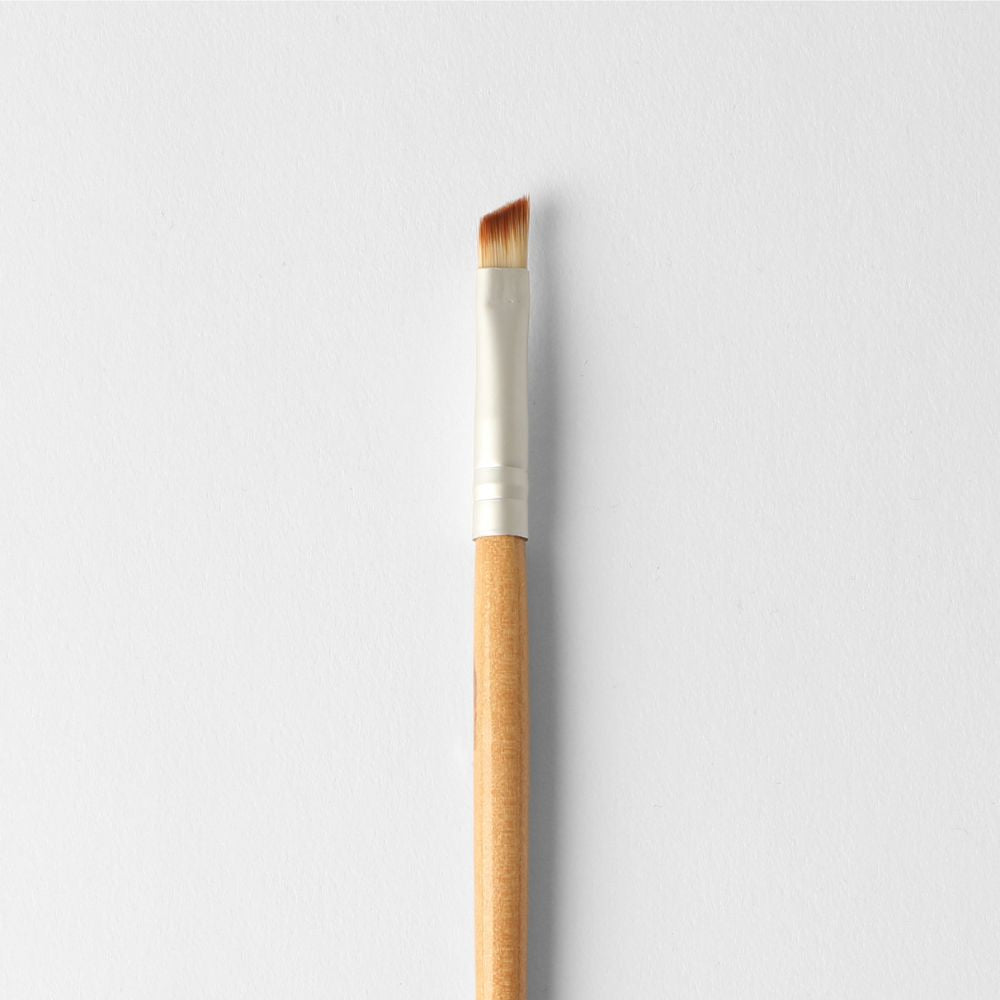 Vegan angled brush for precise shadow placement, suitable for eyes and eyeliner application, eco-friendly and travel-friendly.