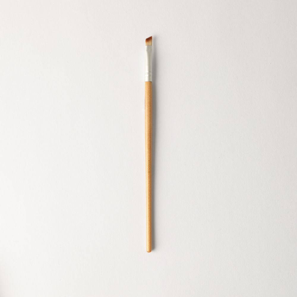 Vegan Angled Brush for precise eye shadow application and eyeliner, compact and travel-friendly, eco-friendly design for smooth, defined results.