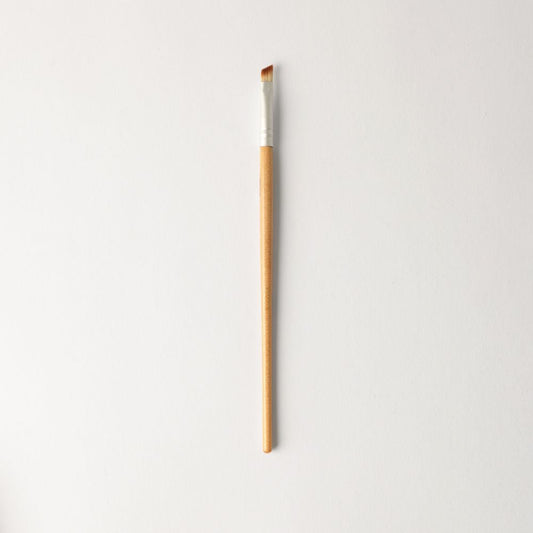 Vegan Angled Brush for precise eye shadow application and eyeliner, compact and travel-friendly, eco-friendly design for smooth, defined results.