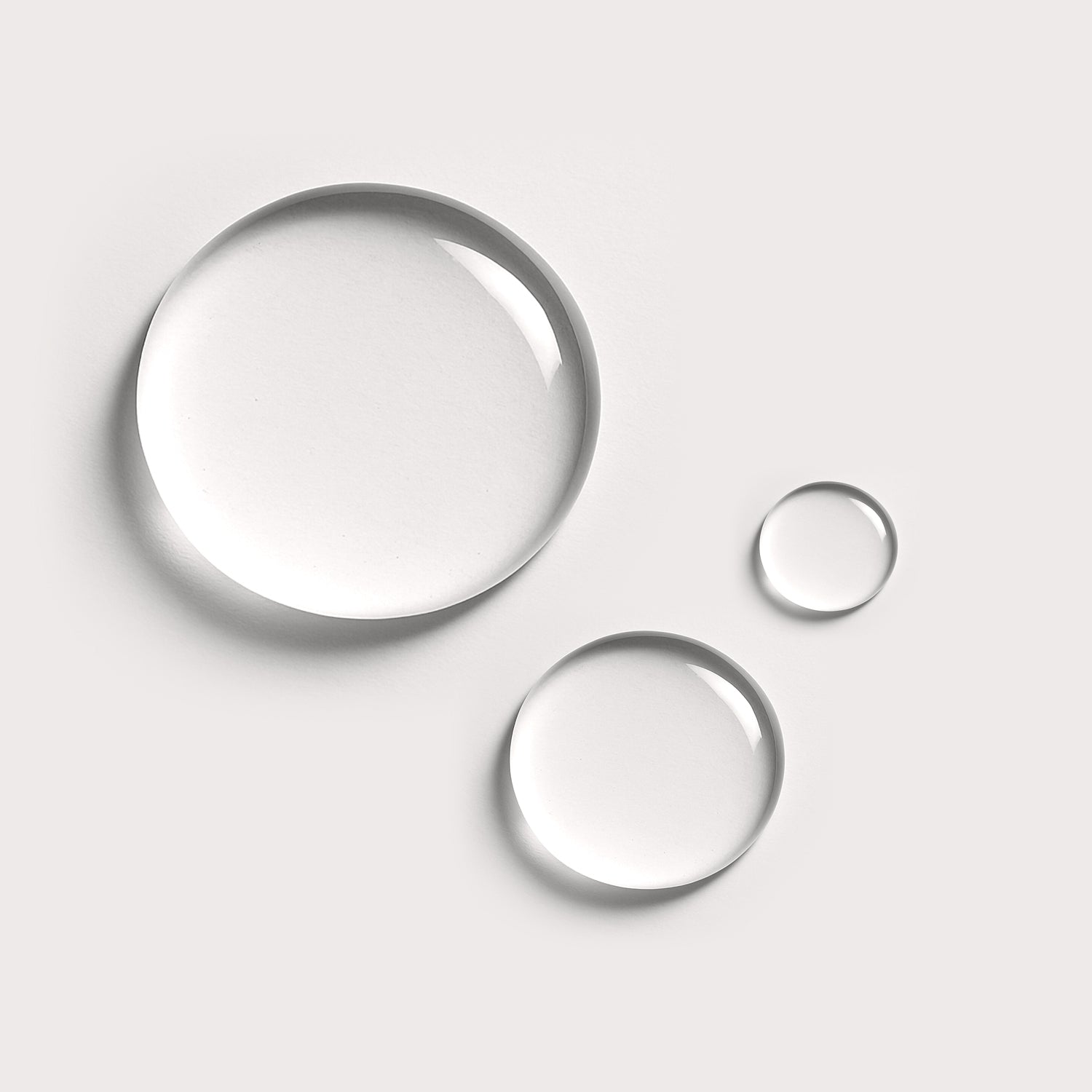 Three droplets of Makeup Remover on a white background, representing the gentle vegan formula ideal for removing makeup without stripping skin.