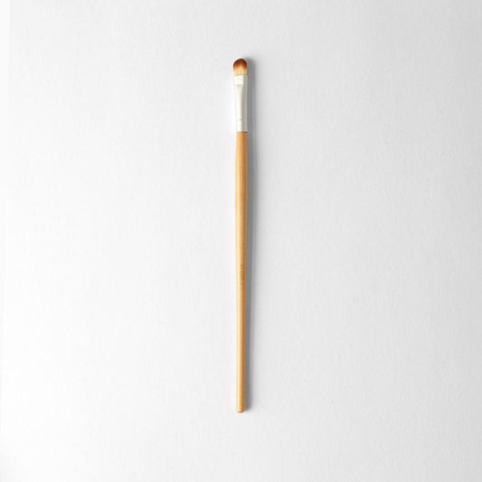 Vegan small eyeshadow brush for precision application and crease definition, eco-friendly wooden handle, perfect for makeup detail.