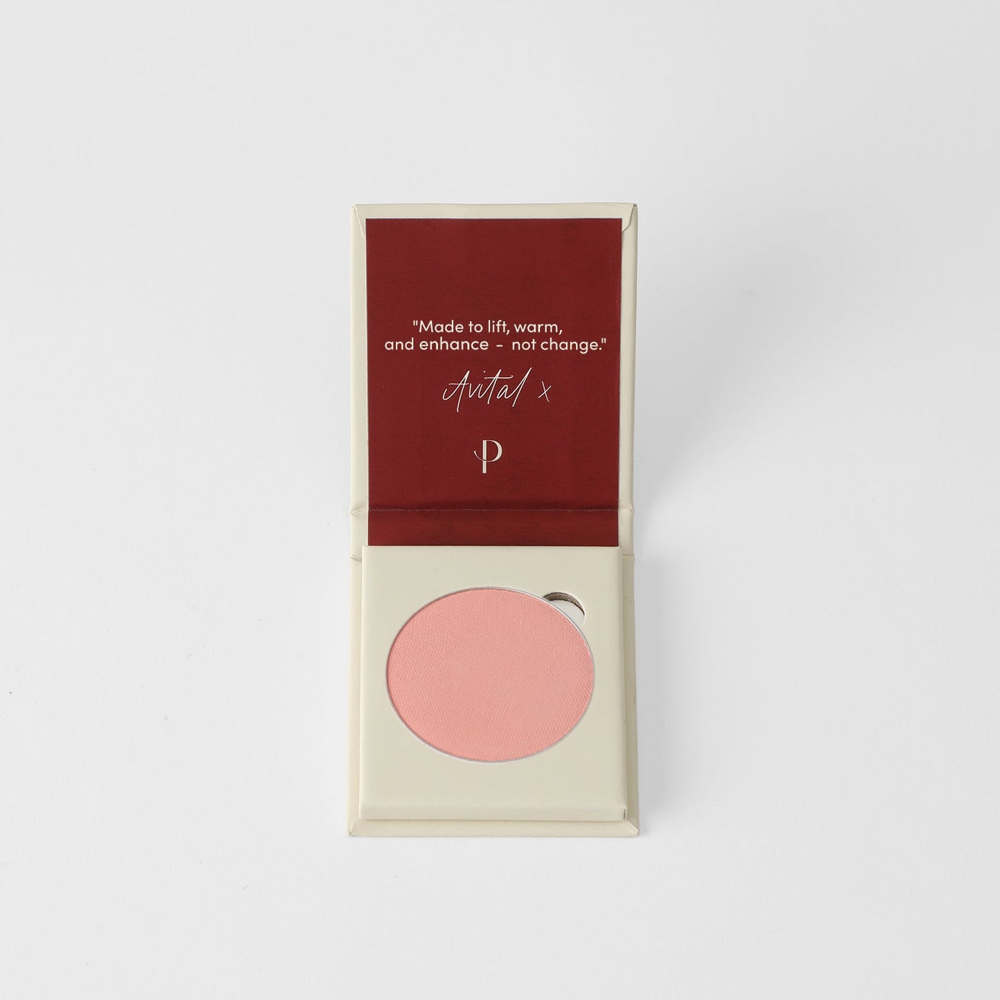 Blush in pink shade inside an open compact with a magnetic palette design for customizable organization.