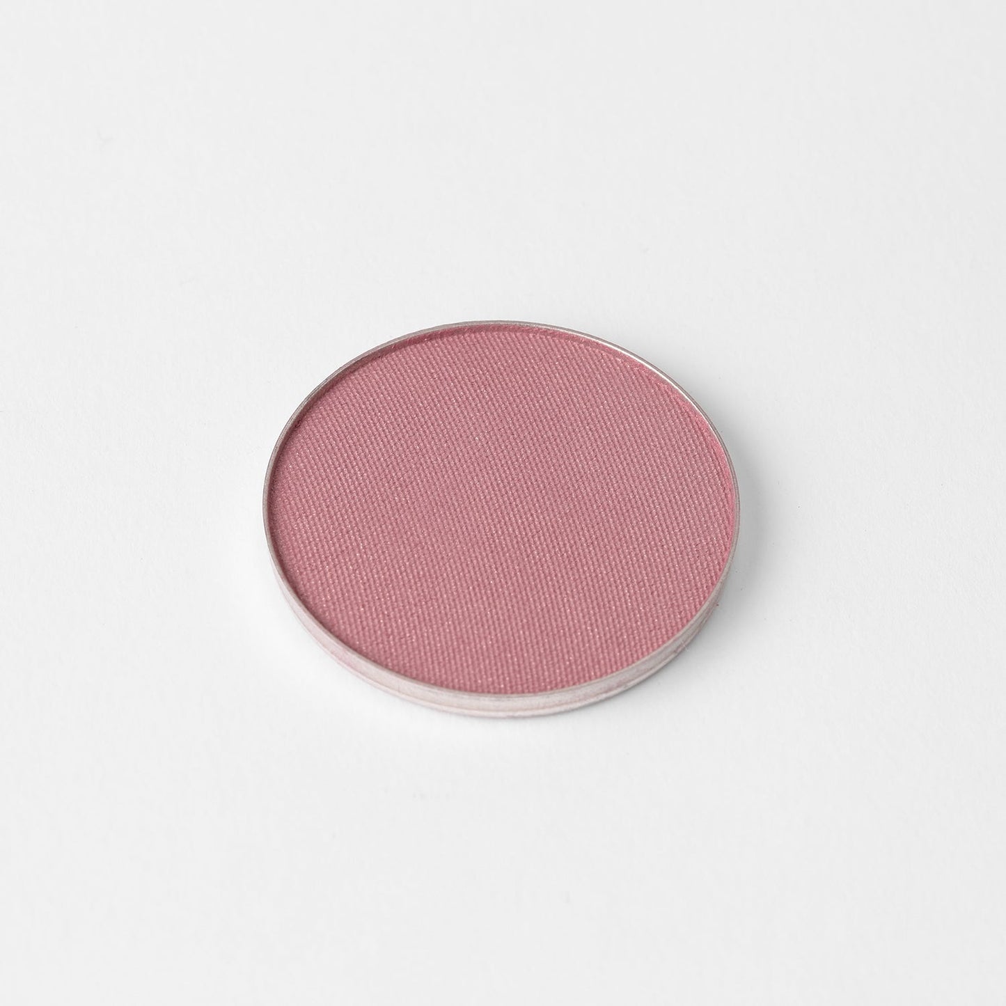 Blush in a soft pink shade, vegan and blendable, perfect for customizable palettes and versatile makeup looks.