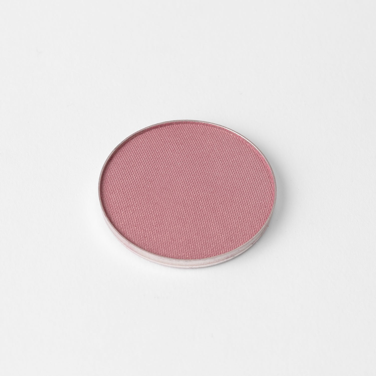Blush in a soft pink shade, vegan and blendable, perfect for customizable palettes and versatile makeup looks.