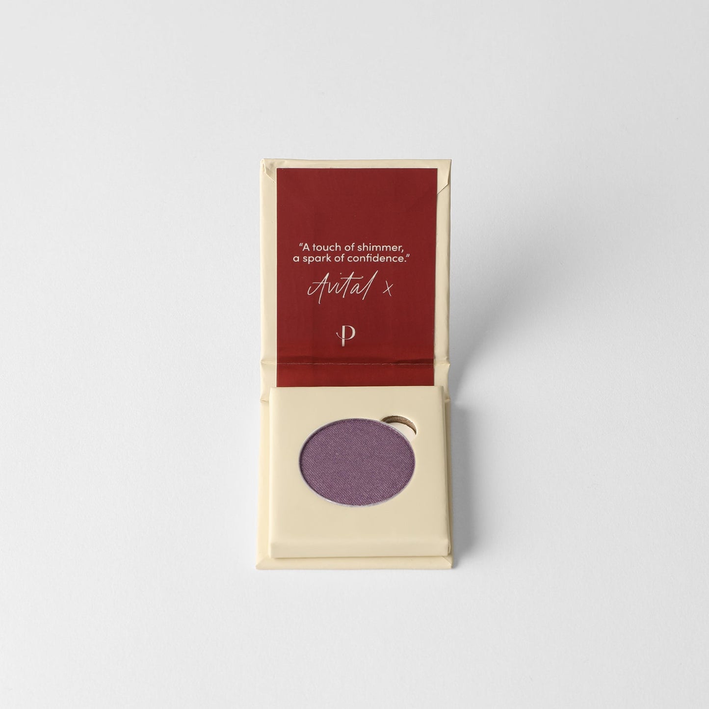 Purple Glow Pressed Eyeshadow in open compact with quote card