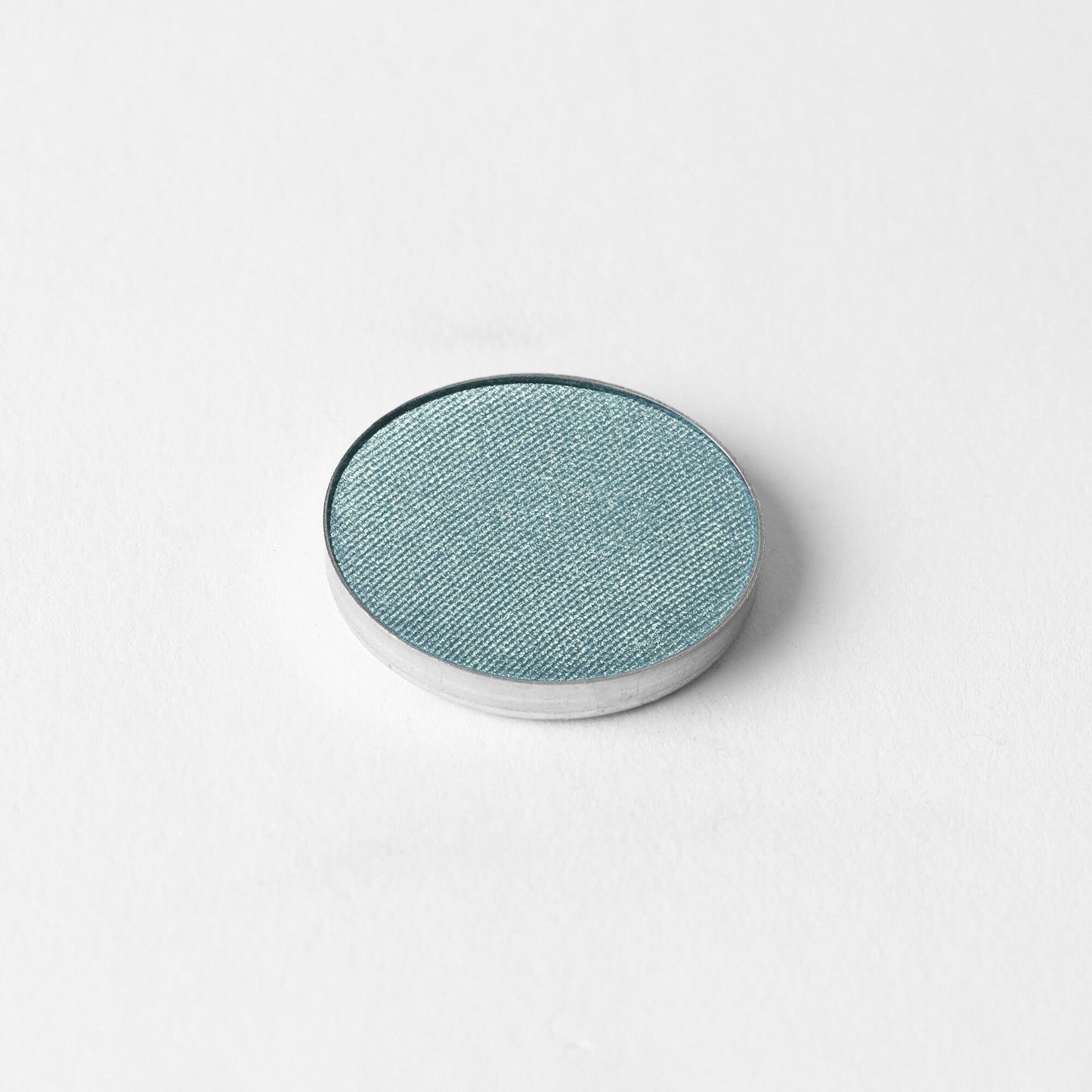Glow Pressed Eyeshadow in metallic pan, showcasing rich vegan pigments for buildable, long-lasting shimmer and definition.