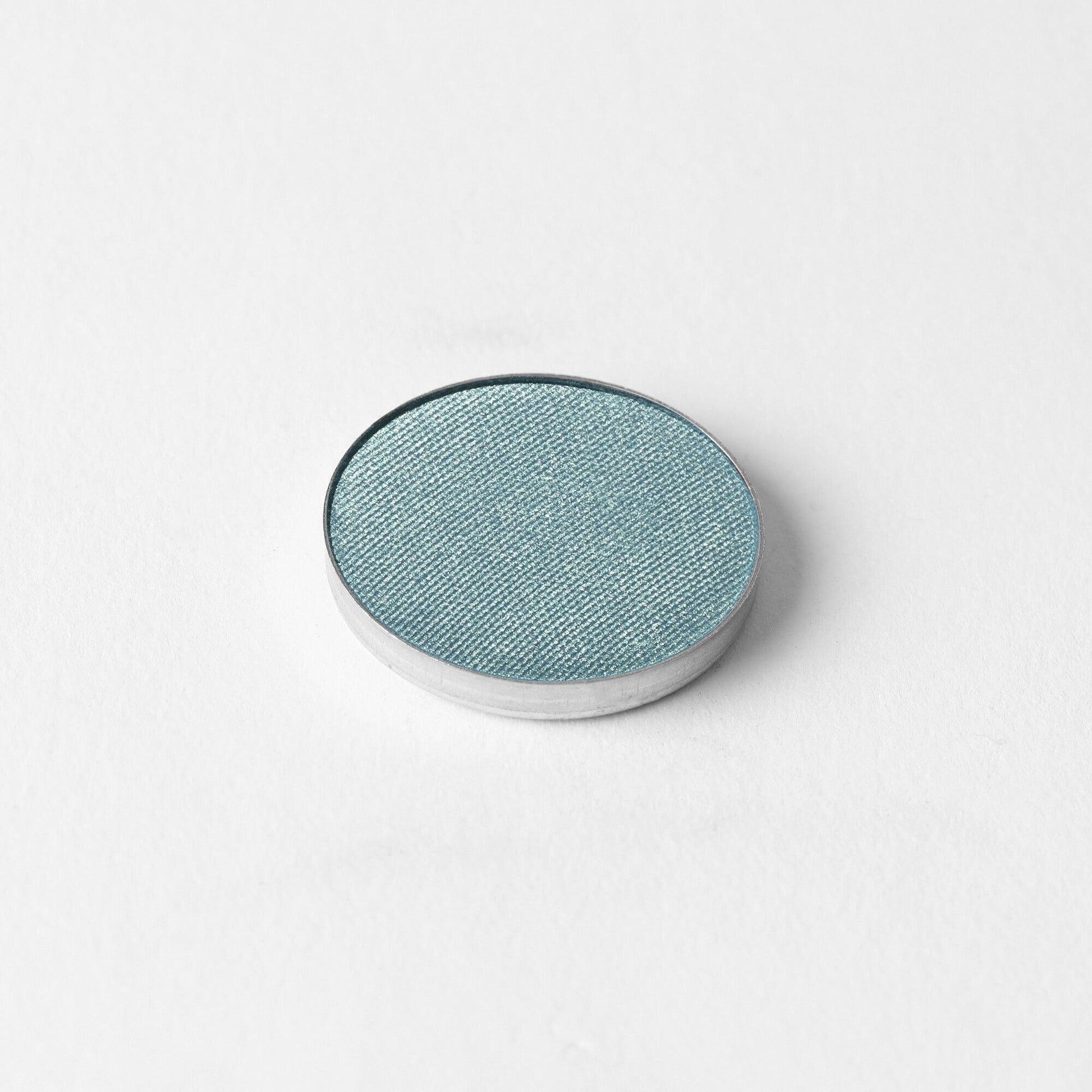 Glow Pressed Eyeshadow in metallic pan, showcasing rich vegan pigments for buildable, long-lasting shimmer and definition.