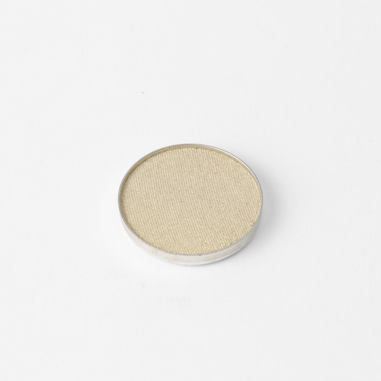 Glow Pressed Eyeshadow single pan in soft shimmer beige, showcasing a luminous finish suitable for layering, lining, and defining.