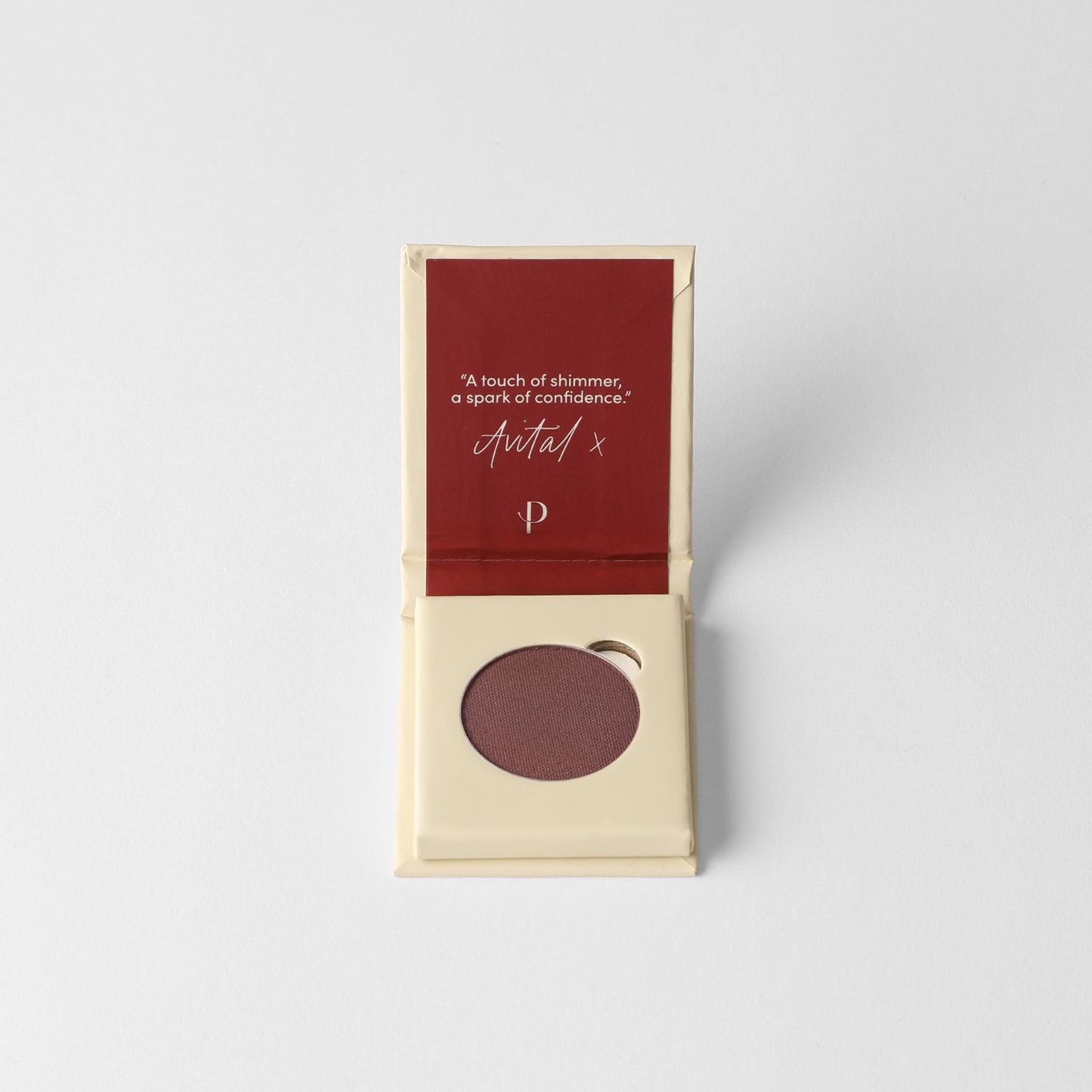 Glow Pressed Eyeshadow in open compact showing rich vegan pigment and packaging inscription.