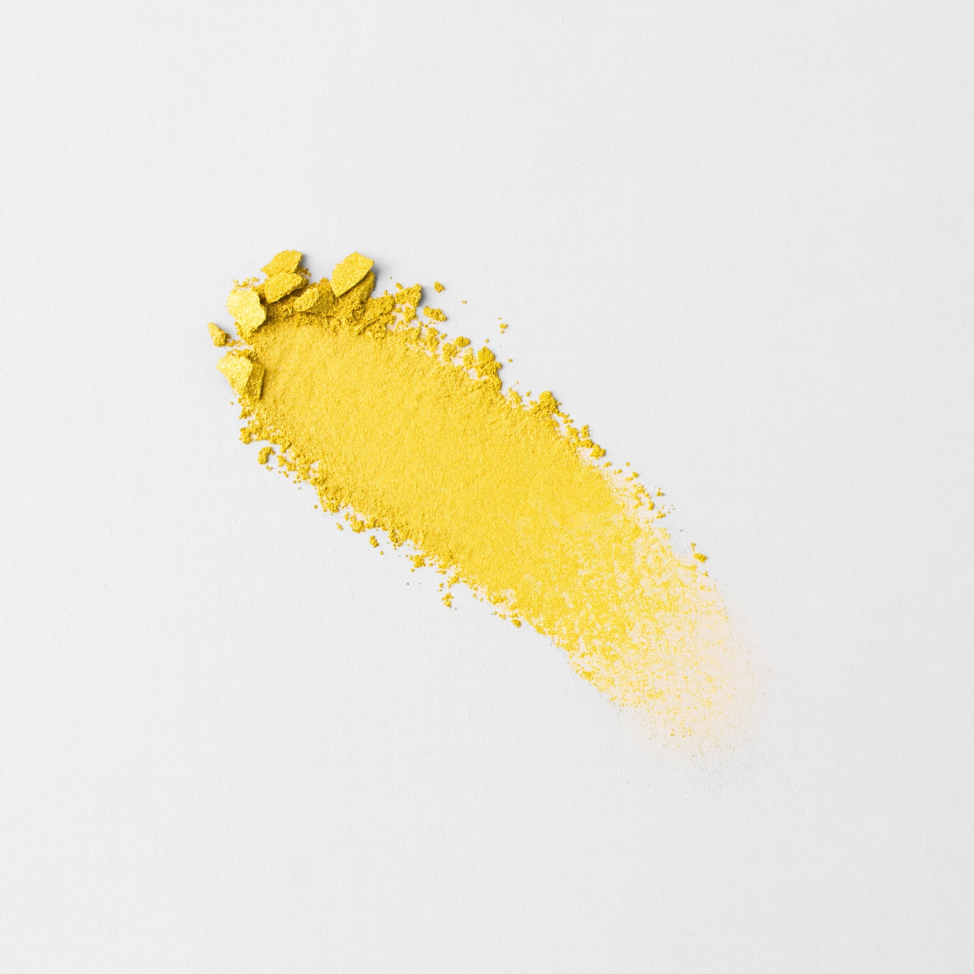 Vibrant yellow Glow Pressed Eyeshadow swatch on white background showcasing rich luminous pigments.