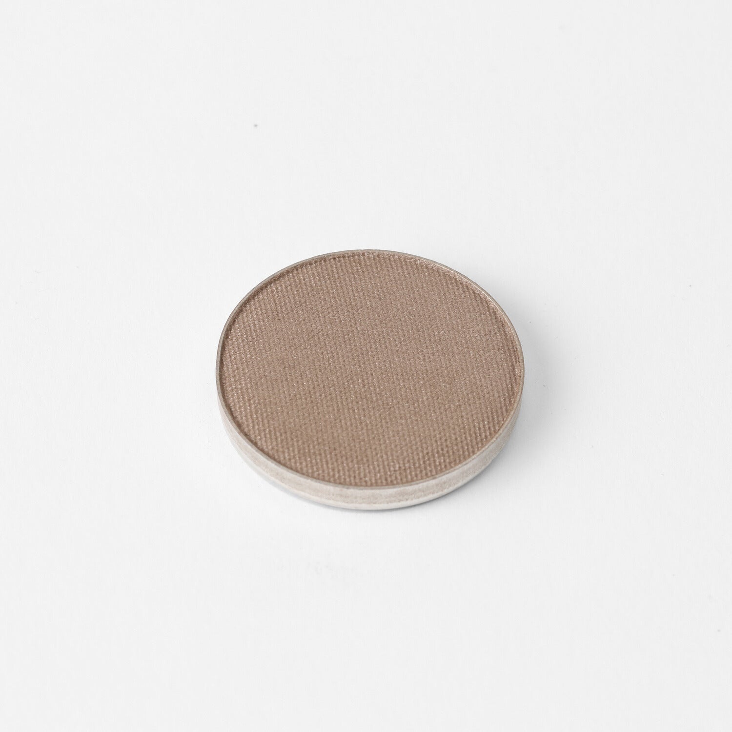 Glow Pressed Eyeshadow in a round pan on a white background, featuring buildable and luminous vegan pigment for eyeshadow applications.