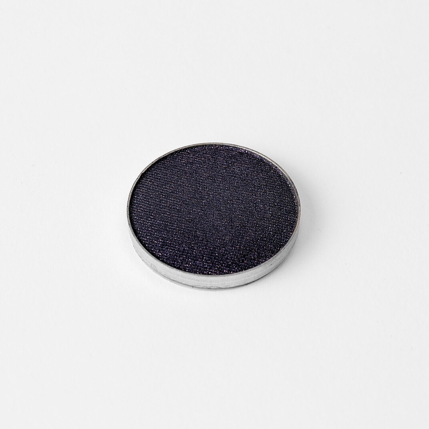 Glow Pressed Eyeshadow in dark shade shown in metal pan, perfect for creating a bold, luminous eye look.