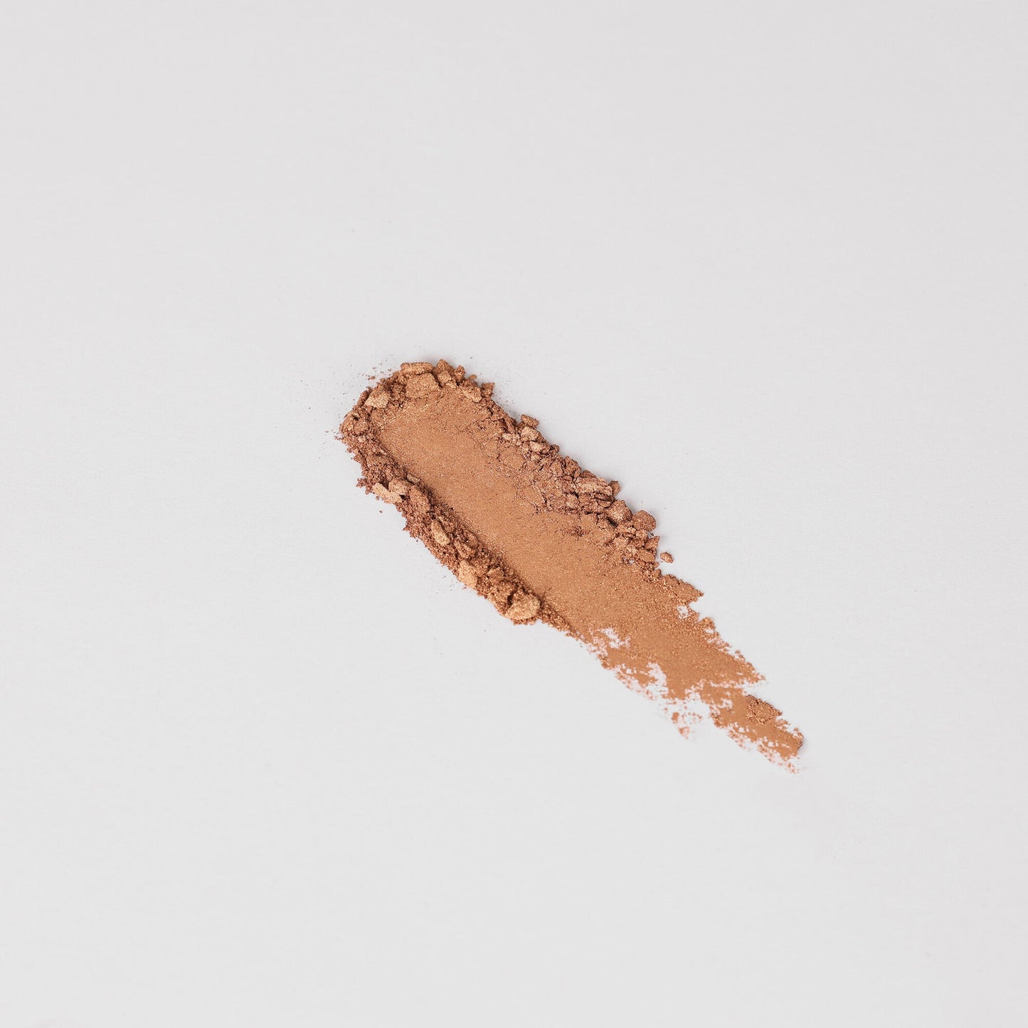 Glow Pressed Eyeshadow swatch showcasing luminous and rich vegan pigments in a soft brown shade on a white background.