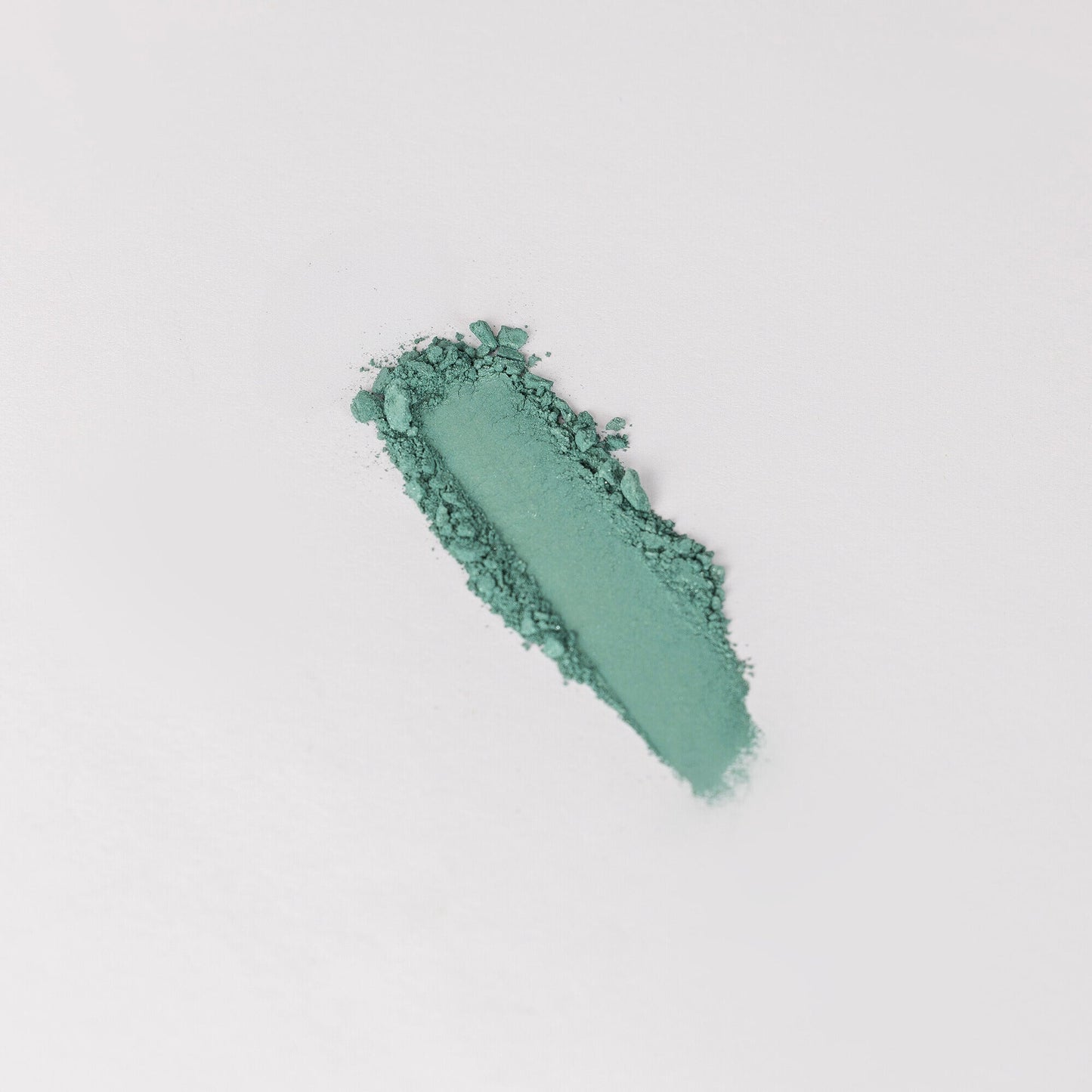 Glow Pressed Eyeshadow swatch showing smooth, blendable green pigment on a white background.