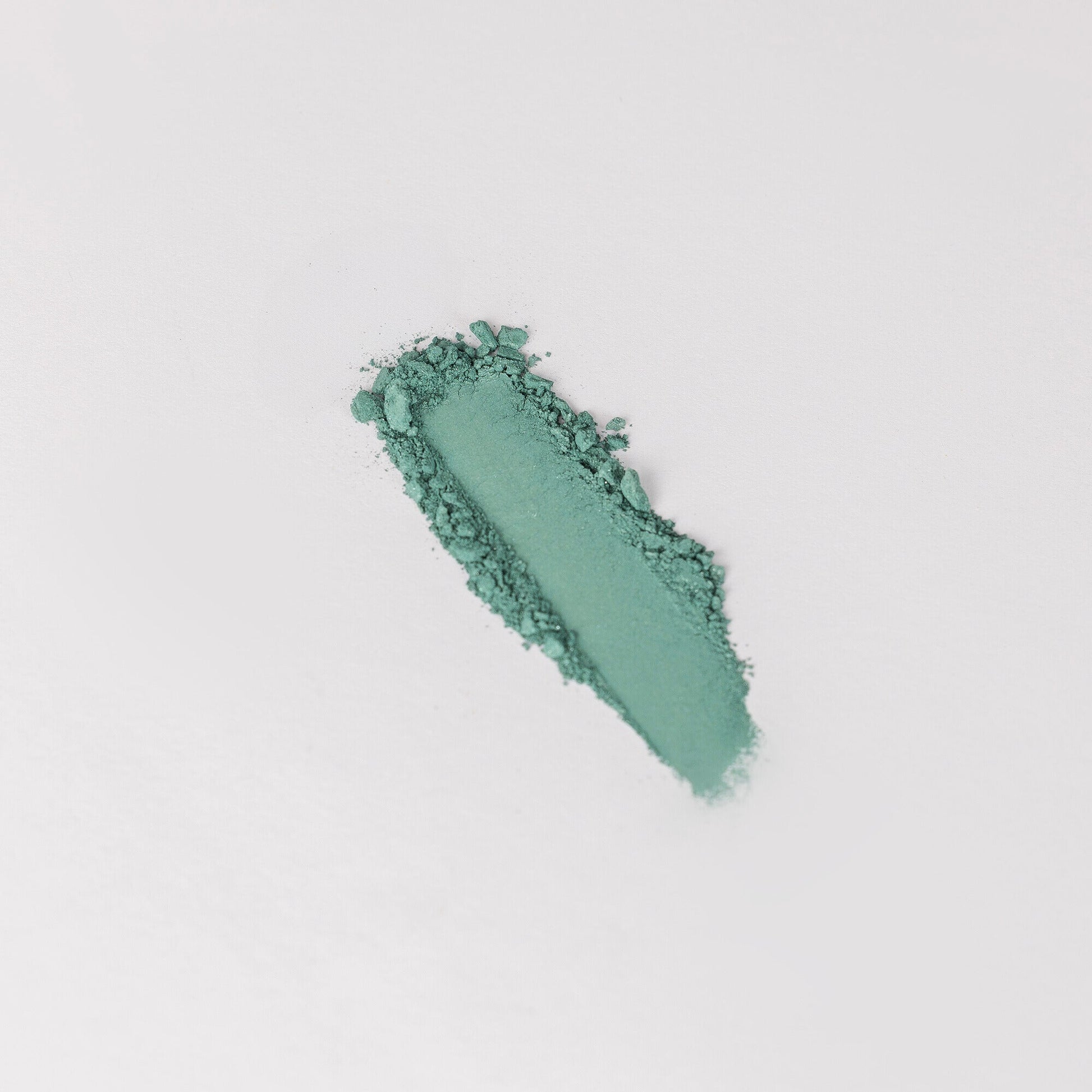 Glow Pressed Eyeshadow swatch showing smooth, blendable green pigment on a white background.
