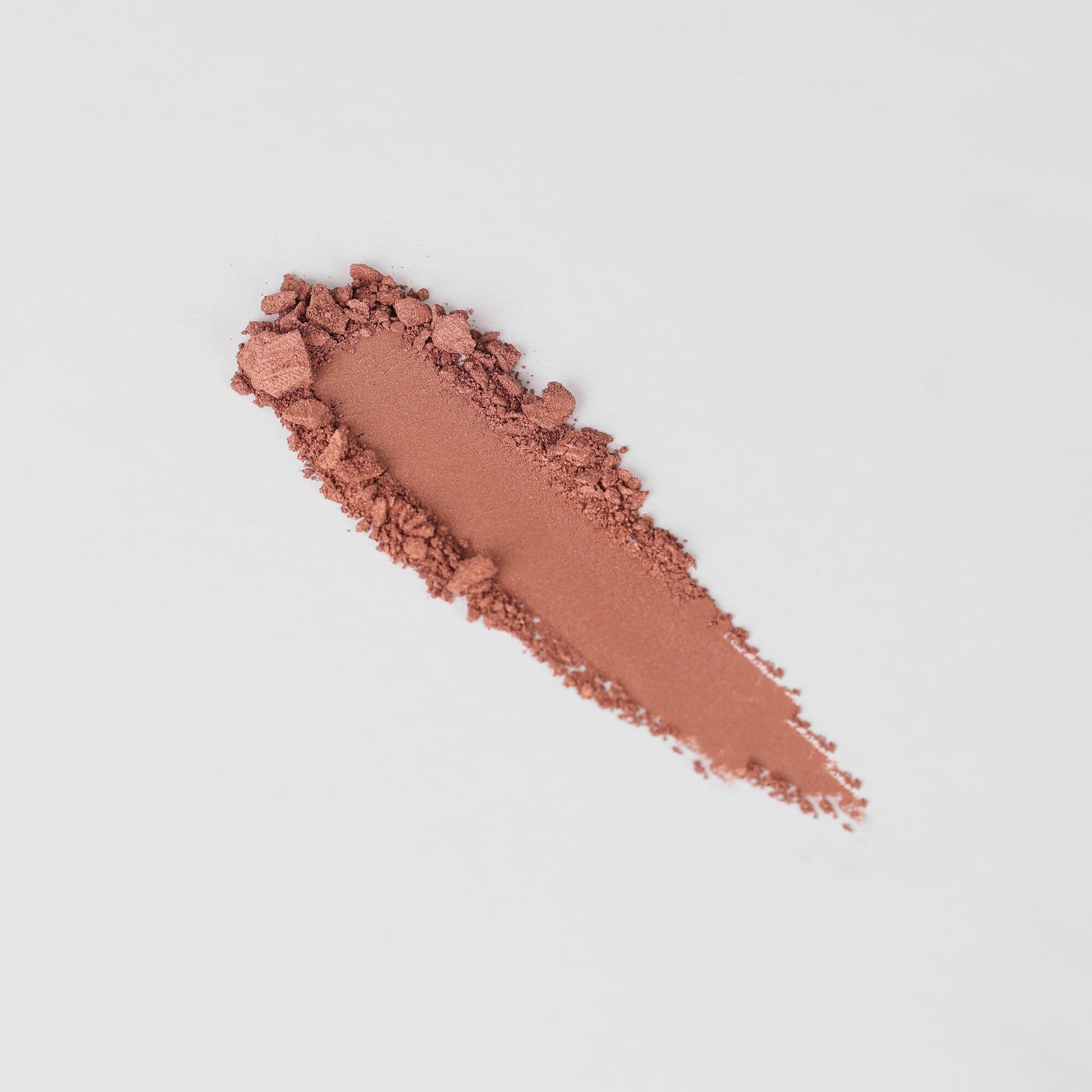 Swatch of Glow Pressed Eyeshadow showcasing rich vegan pigments and smooth application on a white background.