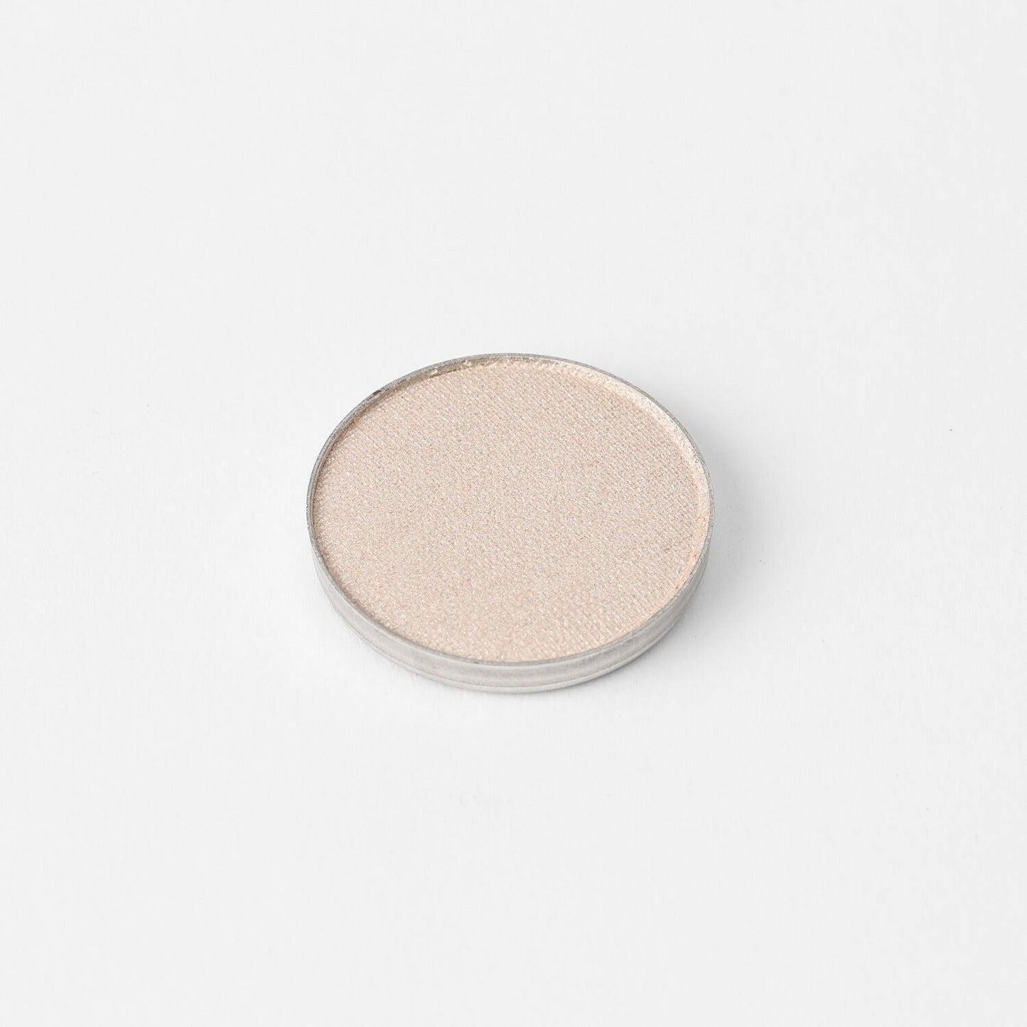 Glow Pressed Eyeshadow in pan showcasing shimmering vegan pigment.