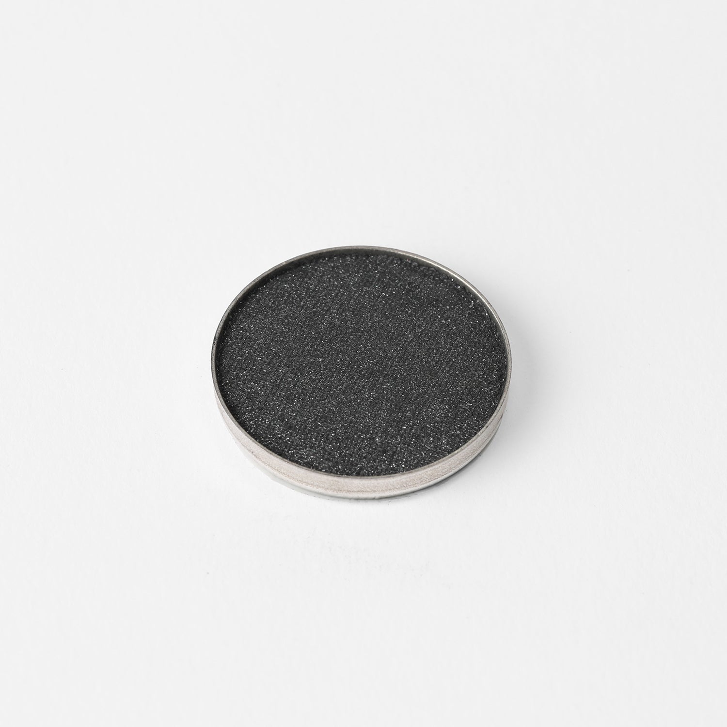 Glow Pressed Eyeshadow in a round pan, featuring luminous pigments for a bold or subtle eye look. Vegan, blendable, and long-lasting.