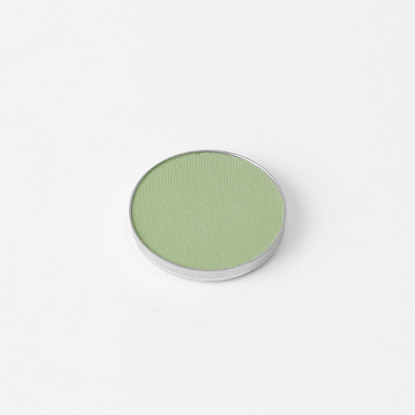 Glow Pressed Eyeshadow in green shade with vegan pigments for blendable and long-lasting wear.