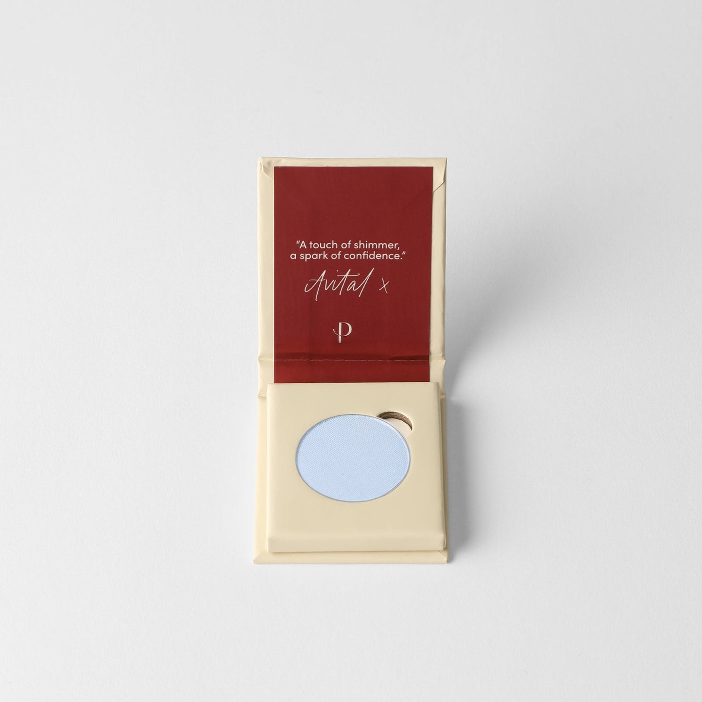Glow Pressed Eyeshadow in light blue shade with open compact showcasing vegan pigments.