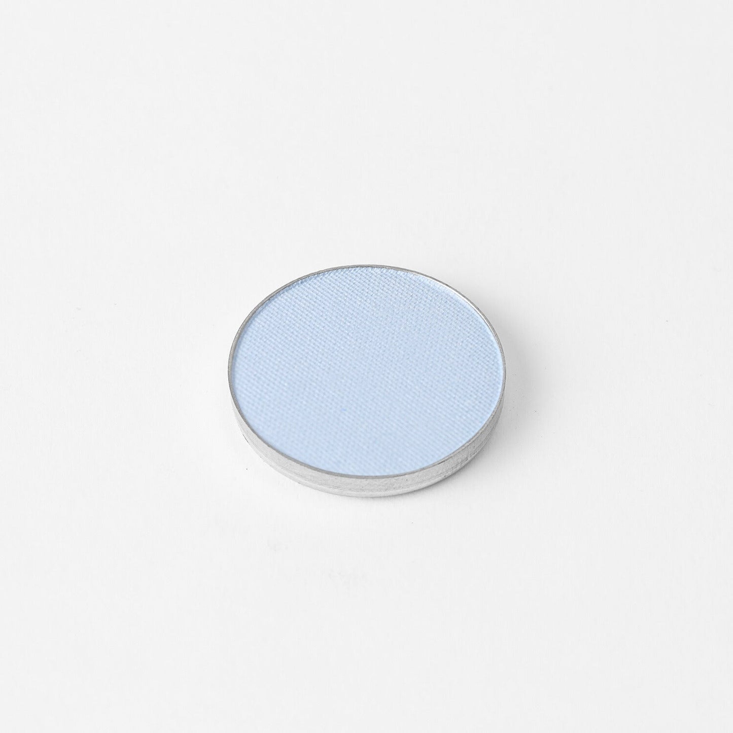 Glow Pressed Eyeshadow in light blue, vegan and buildable pressed shadow for versatile eye makeup looks, shown in single pan.