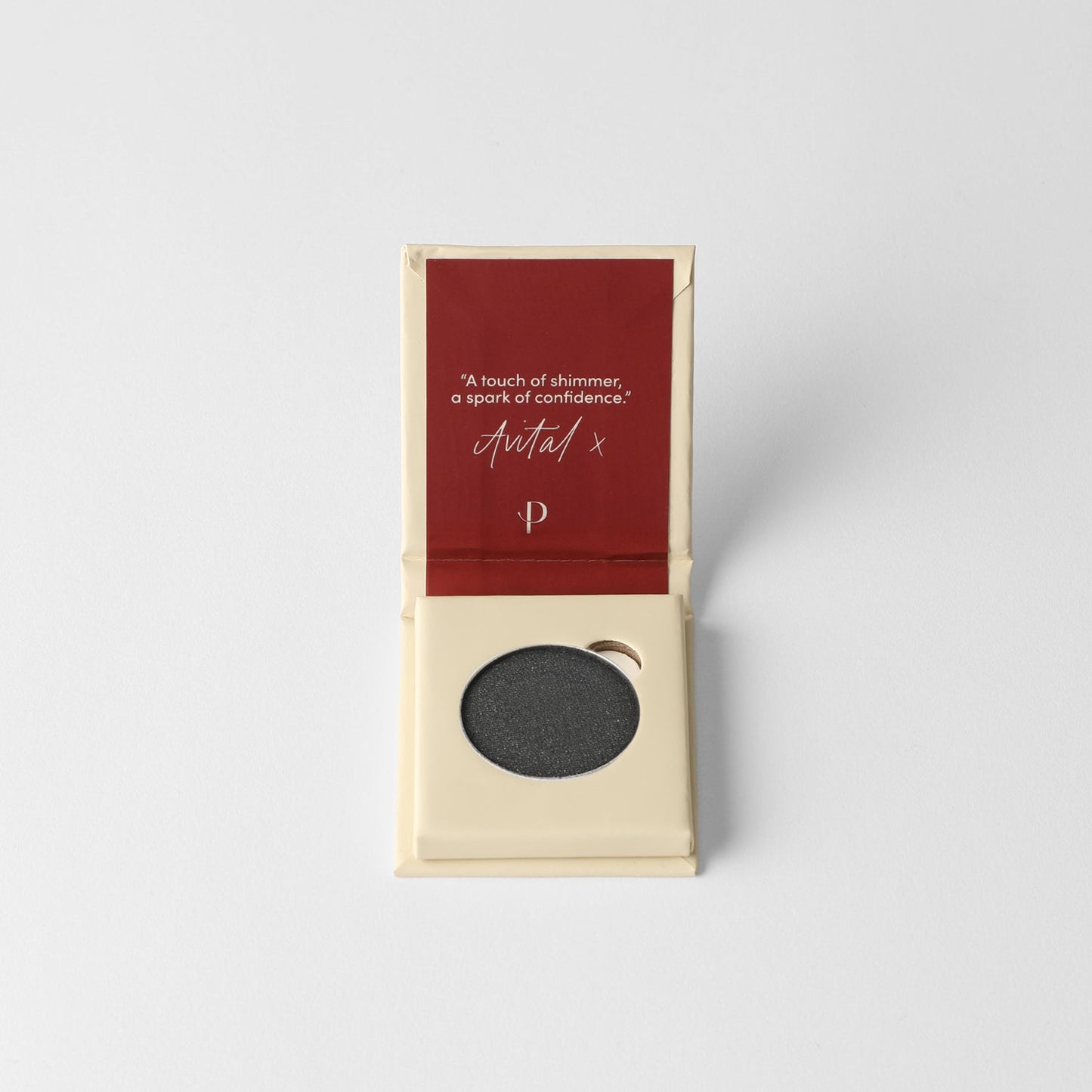 Glow Pressed Eyeshadow in an open compact with a dark shade, perfect for creating luminous eye looks with rich vegan pigments.